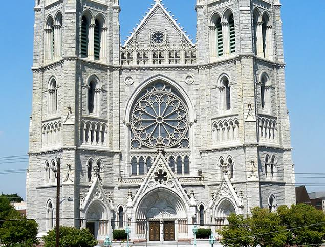 Beautiful Catholic church exterior with Gothic stone façade and twin towers